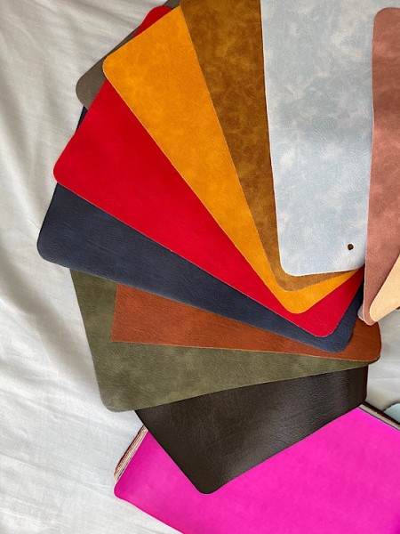 A leather bag made of artificial leather with a wreath design